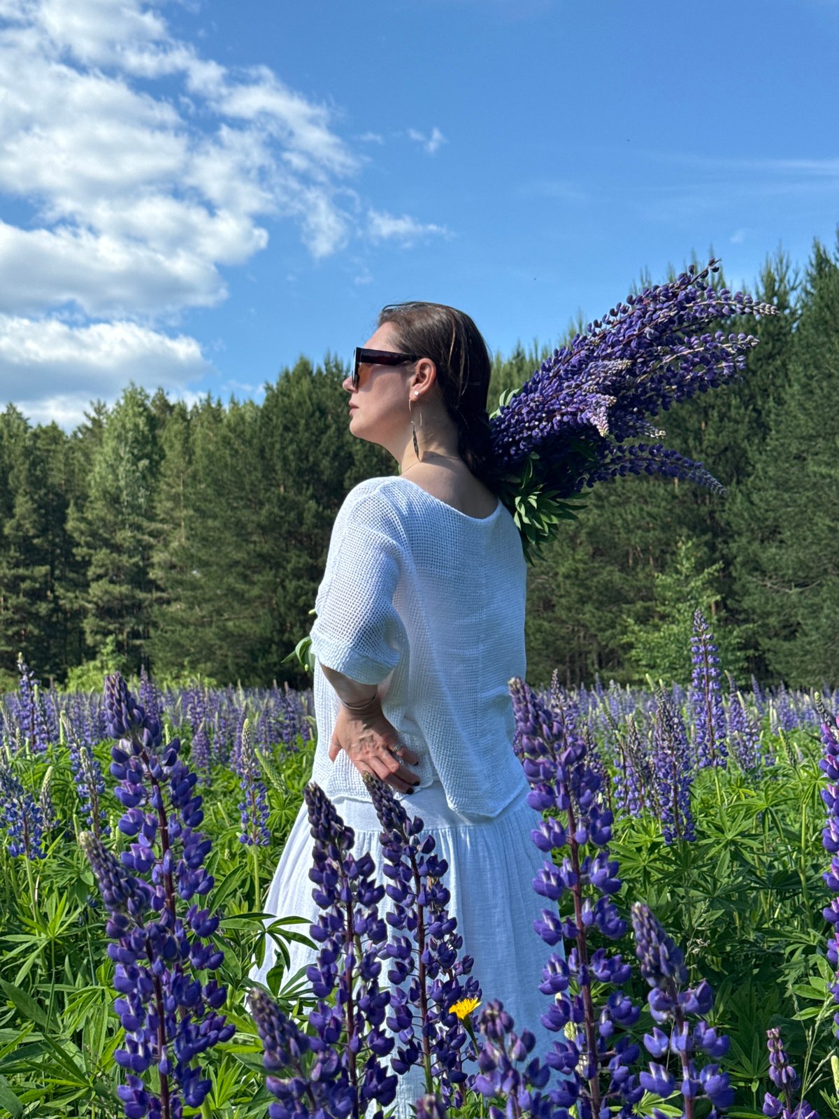 Woman photographed in lupine fields, forest paths near Chaikovsky