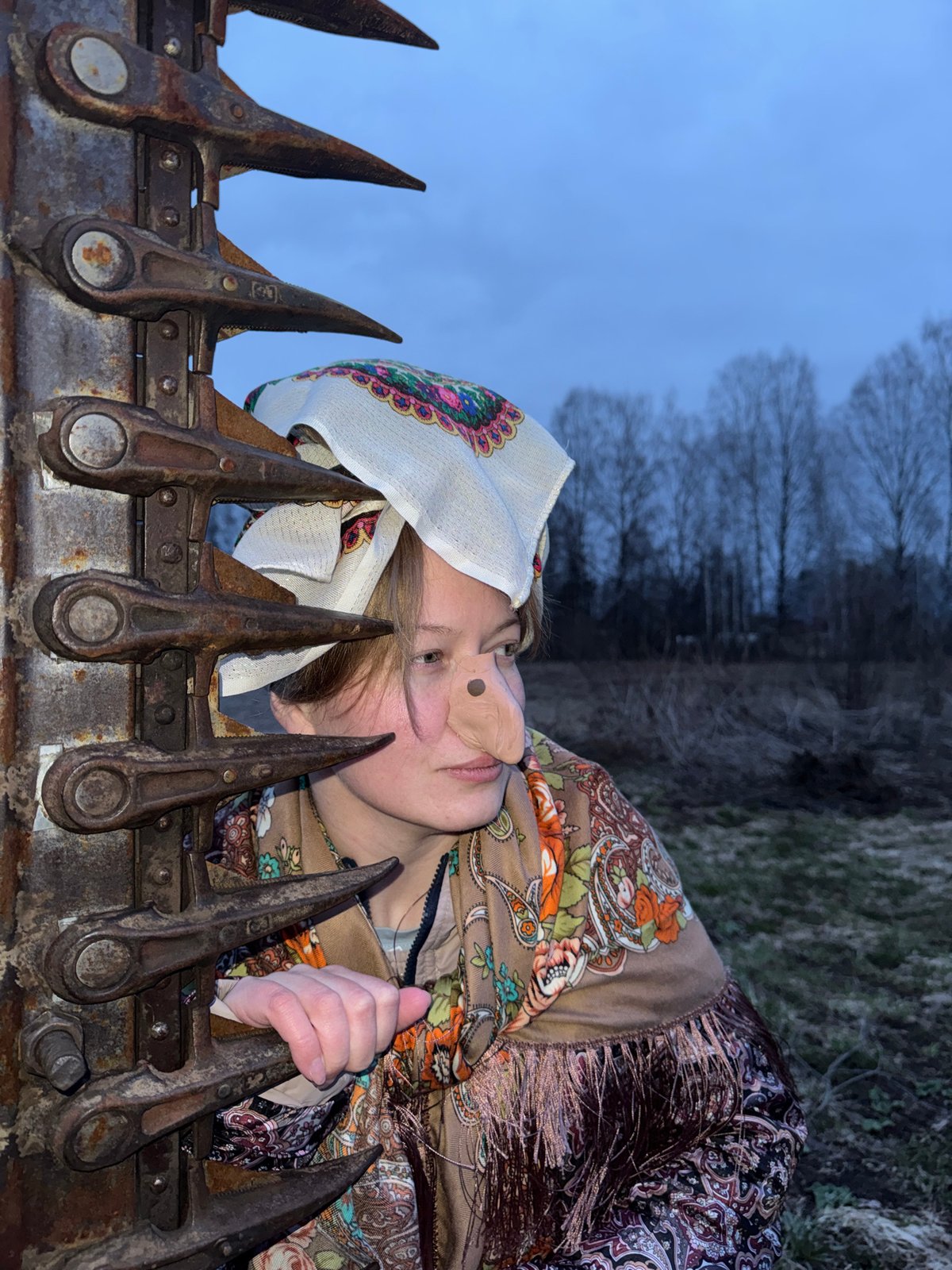 Woman in floral headscarf documented across Вассята, Russia