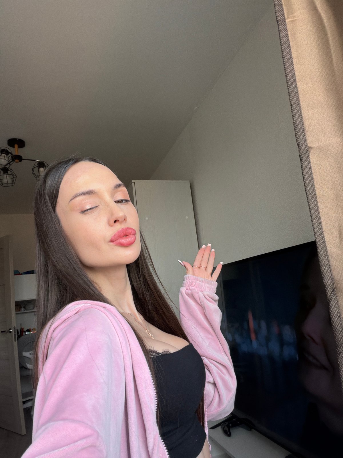Woman documents personal photo session in Saint Petersburg apartment