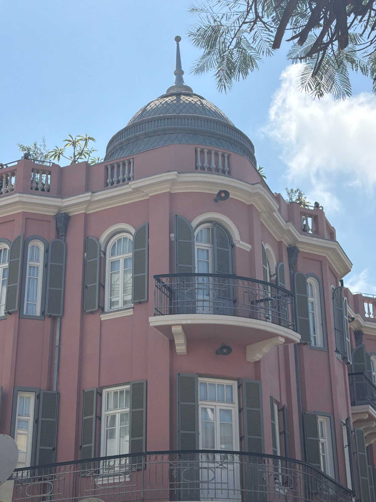 Street musician performs in Tel Aviv amid distinctive architecture