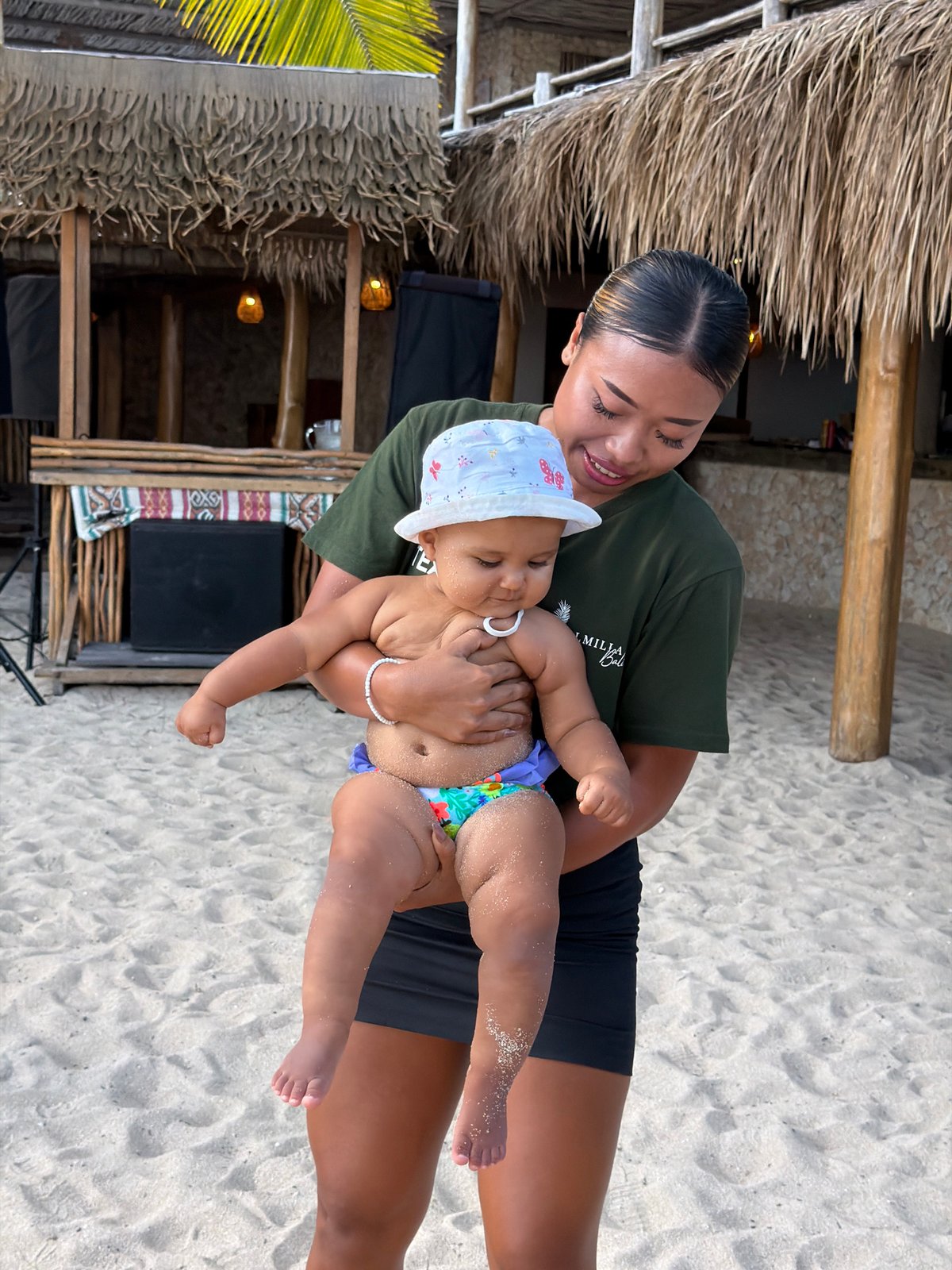 Lazy morning on the sand in Kuta Selatan with a baby in tow
