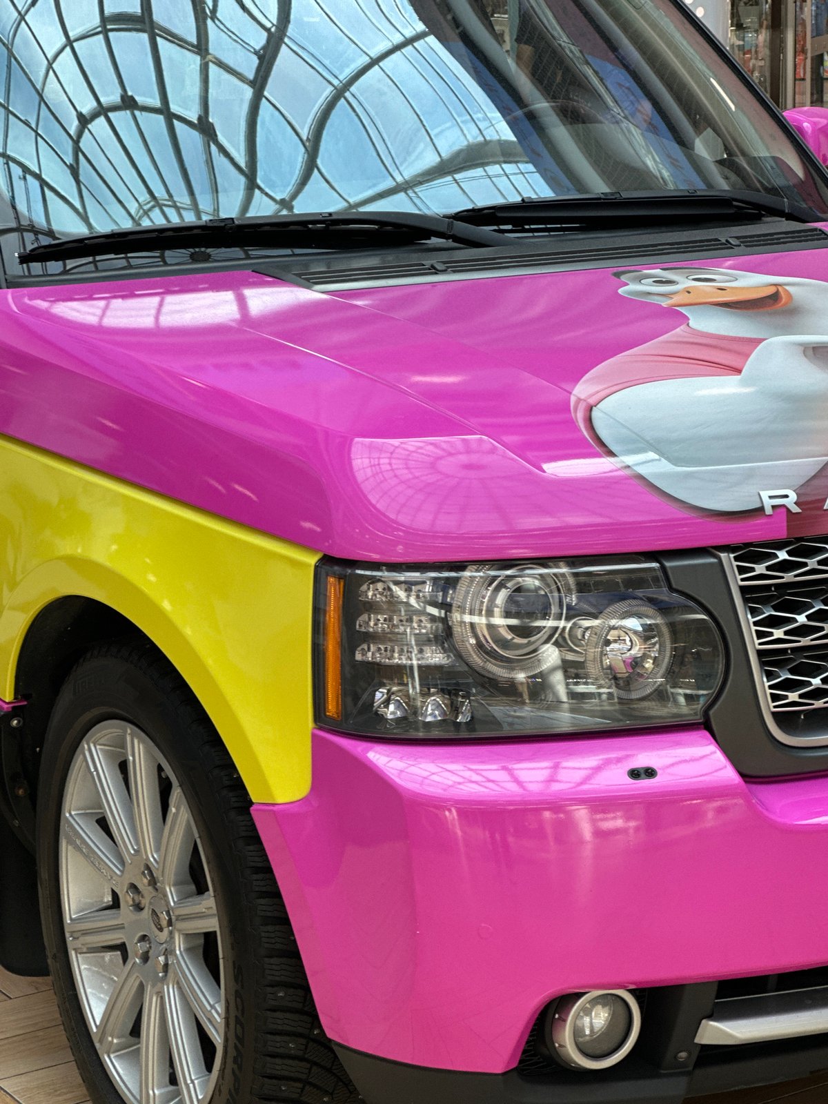Pink Range Rover with duck graphics displayed in Minsk mall