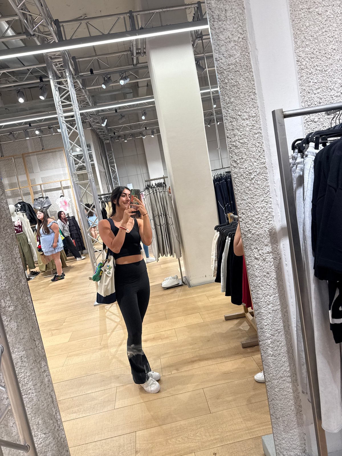 Woman takes mirror selfie while shopping in Puebla store