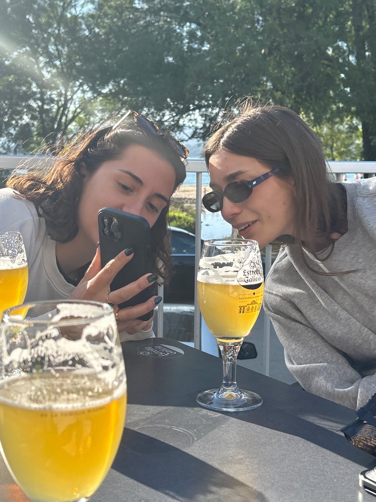 Women relax with dog on patio in O Porto do Son