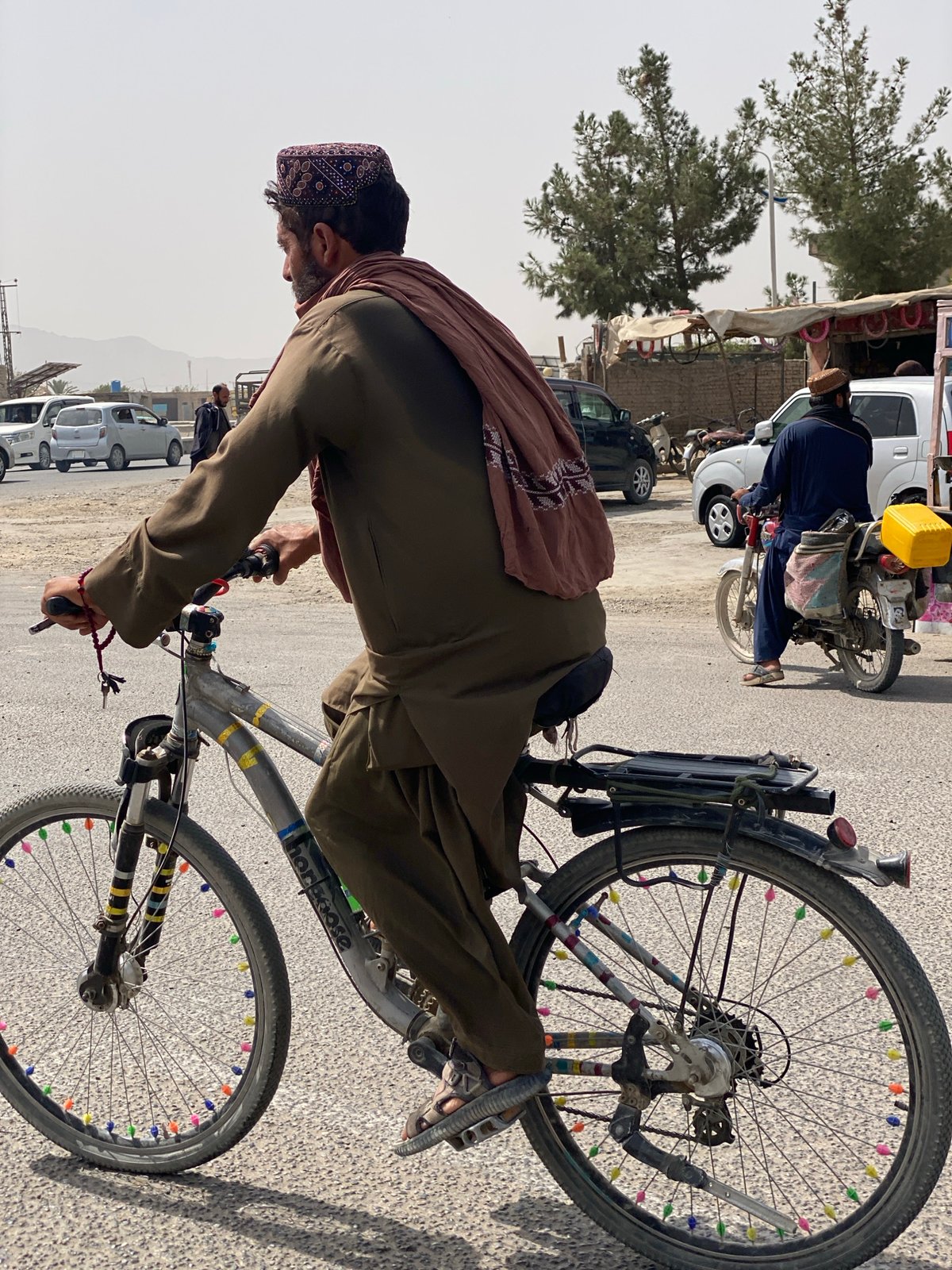 Kandahar street life: vendors, cyclists, and utility vehicles