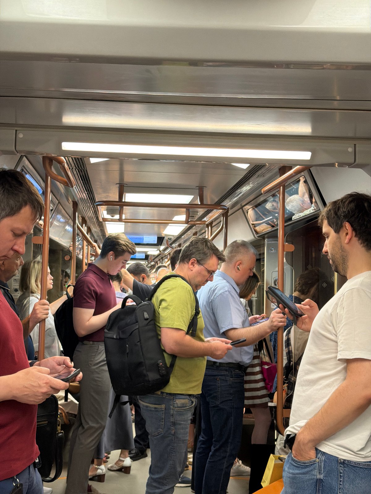 Moscow metro passengers use phones during morning rush hour