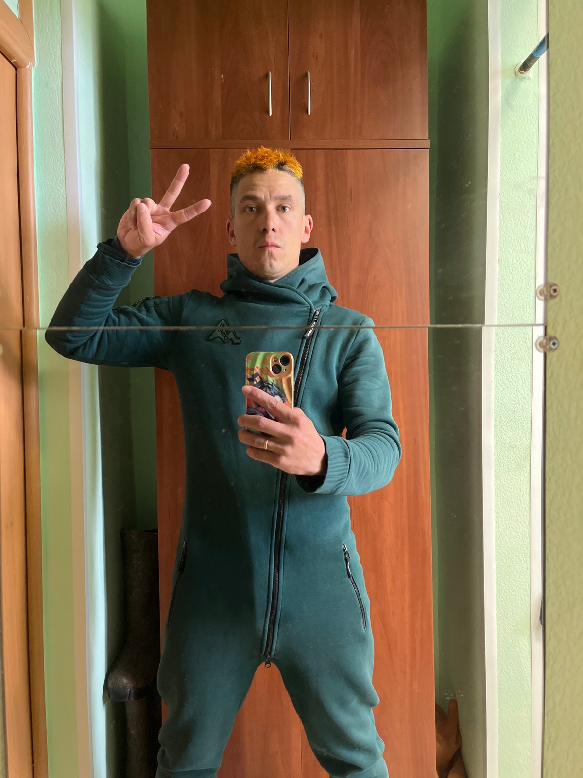 Man takes mirror selfie in jumpsuit in Chaikovsky