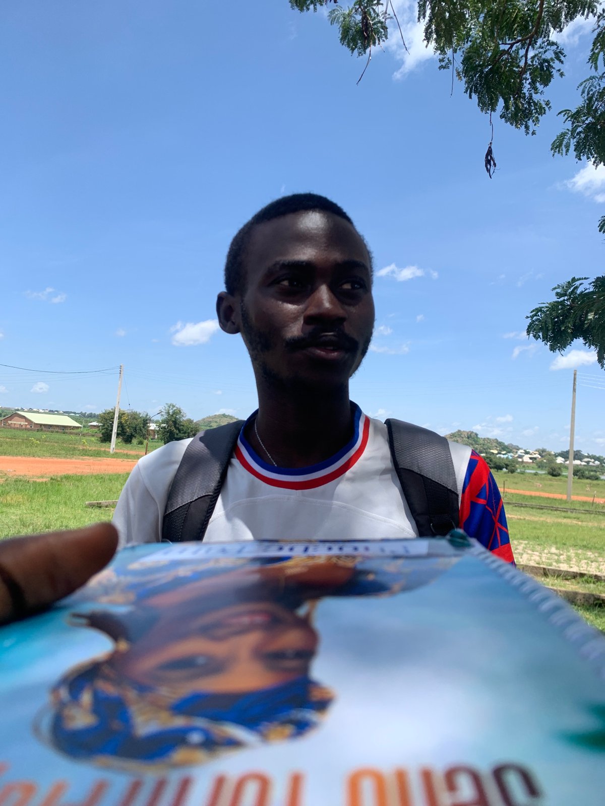 Group hangout in Gwafan with a Nigerian flag flying nearby