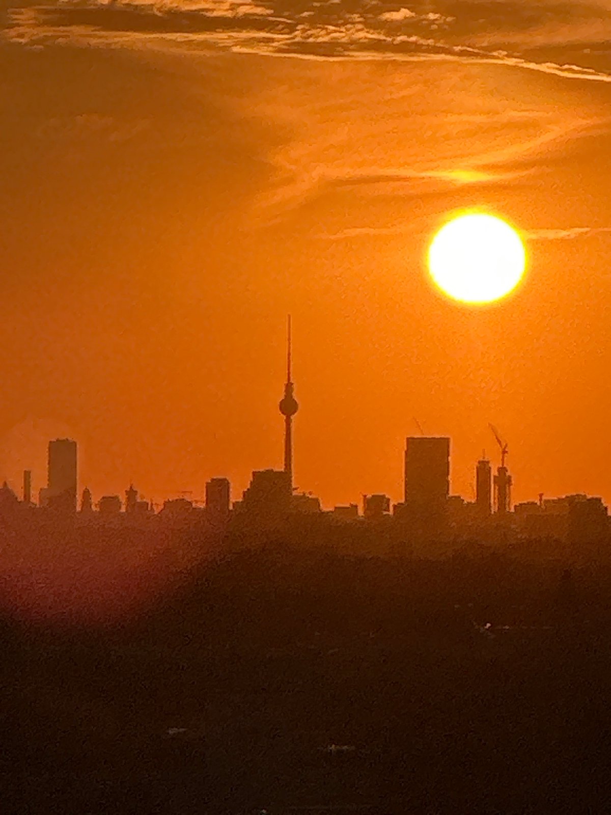 Berlin skyline glows under a warm July sunset