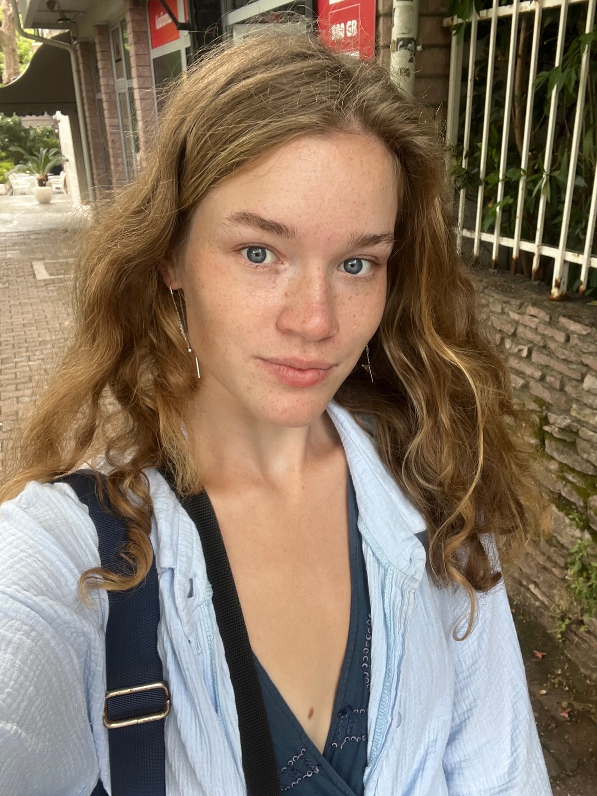 Woman films selfie videos on stone pavement in Budva