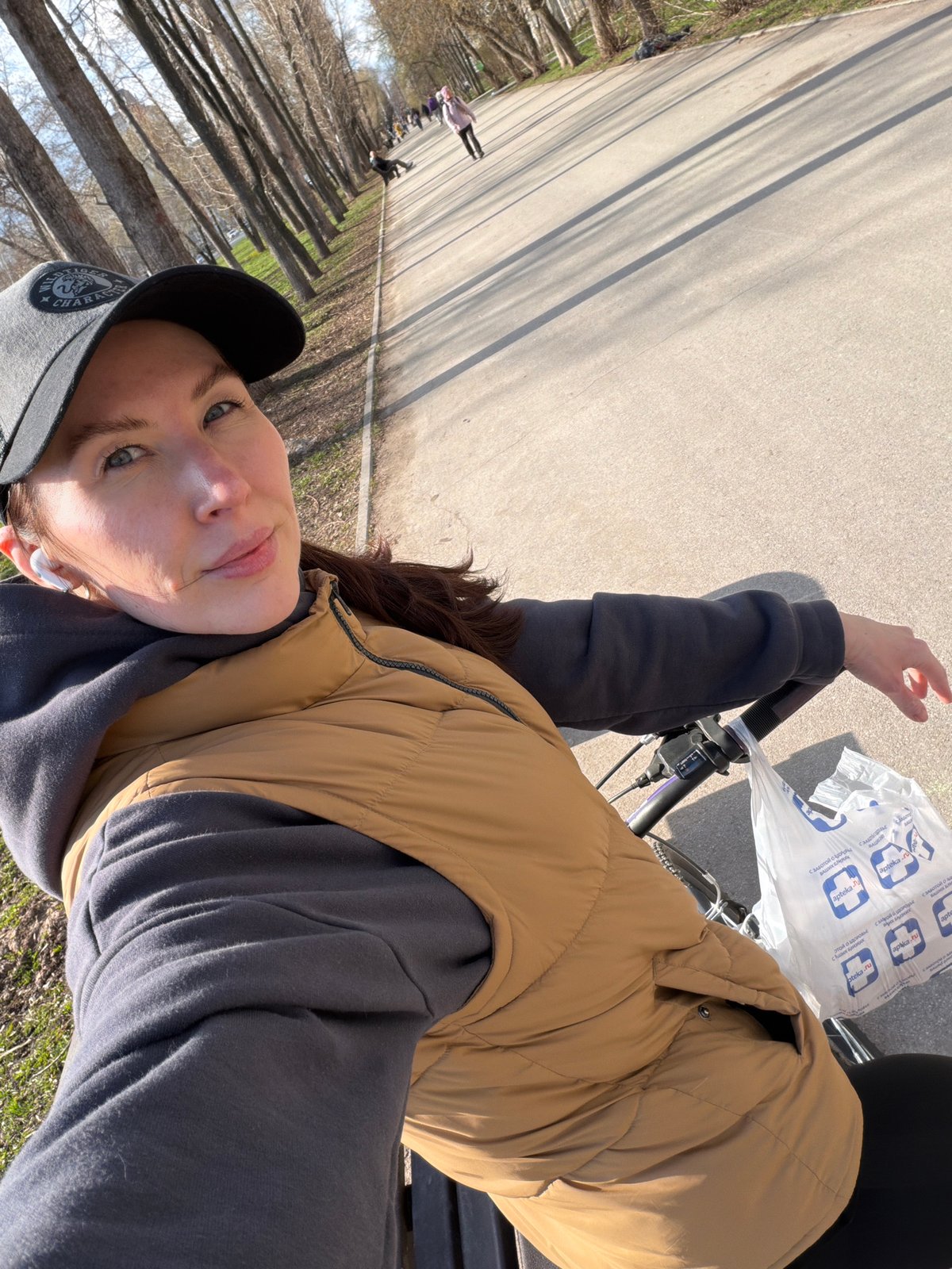 Woman cycles through Perm carrying pharmacy bag