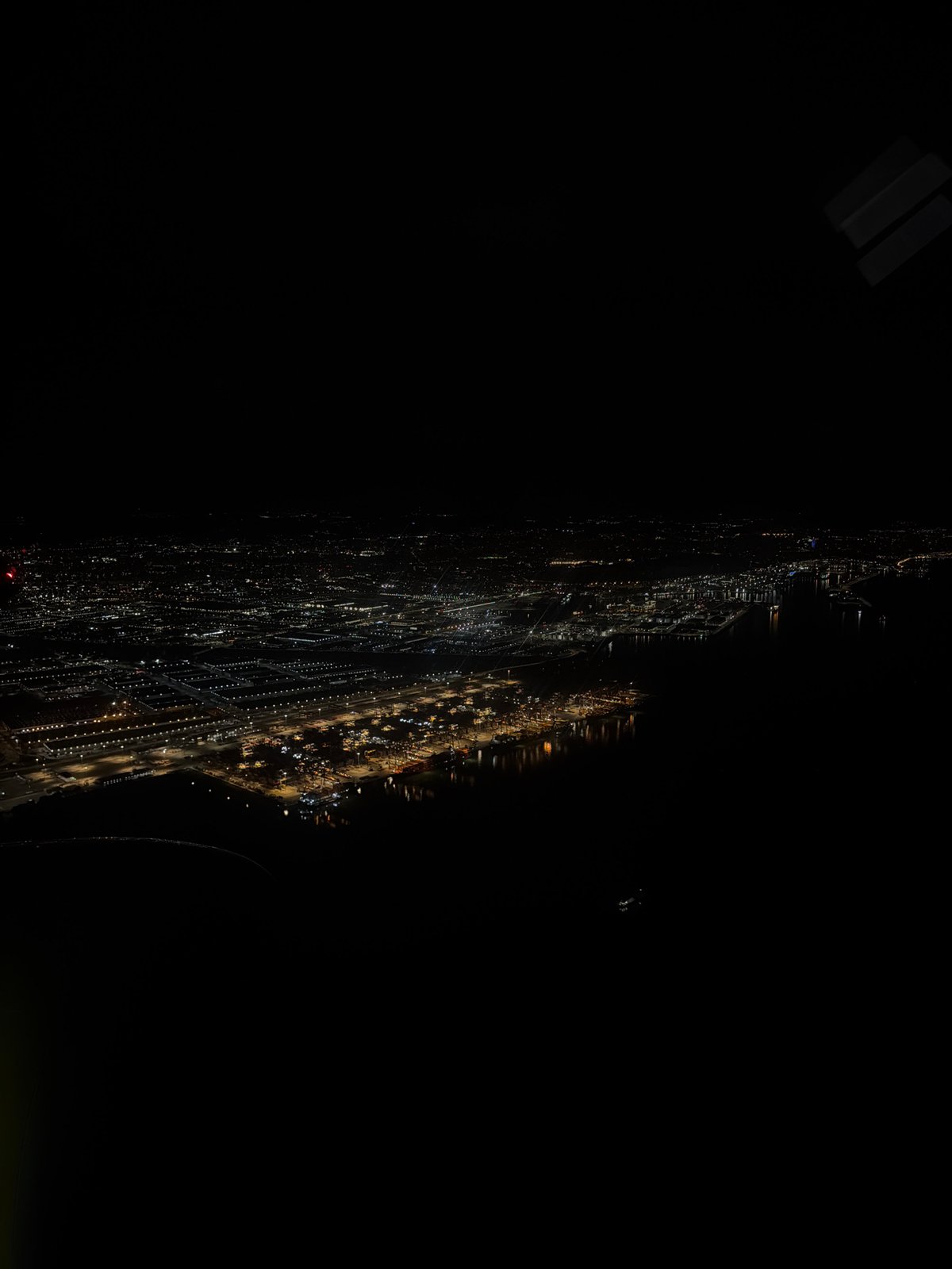 Aerial nighttime view captures sprawling Barcelona urban lights