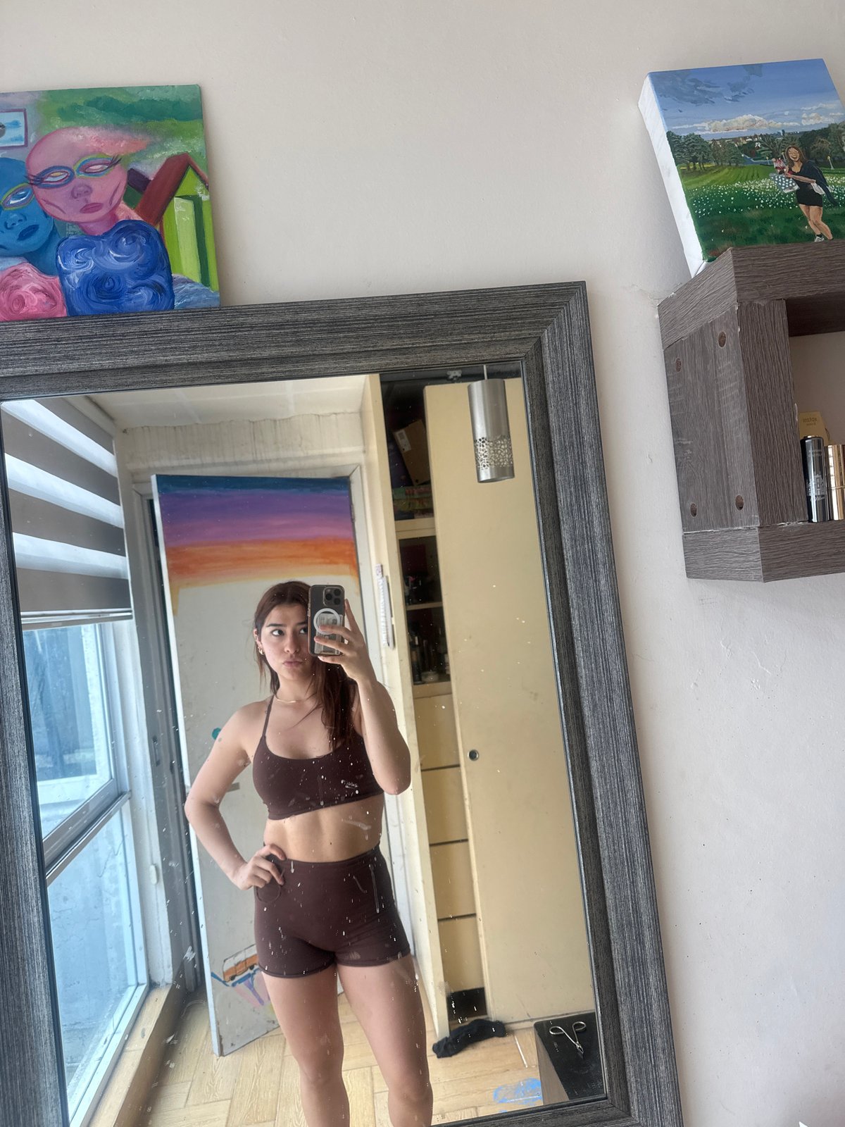 Person takes mirror selfie in athletic wear in Puebla