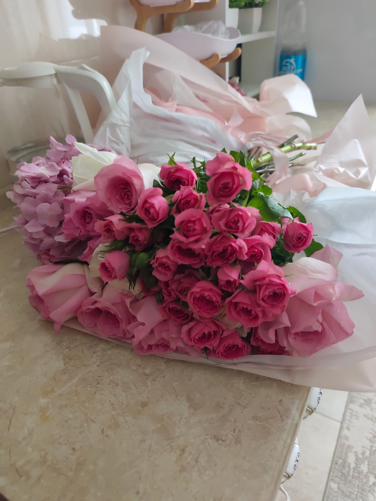 Pink and white roses arranged at a home in Astana