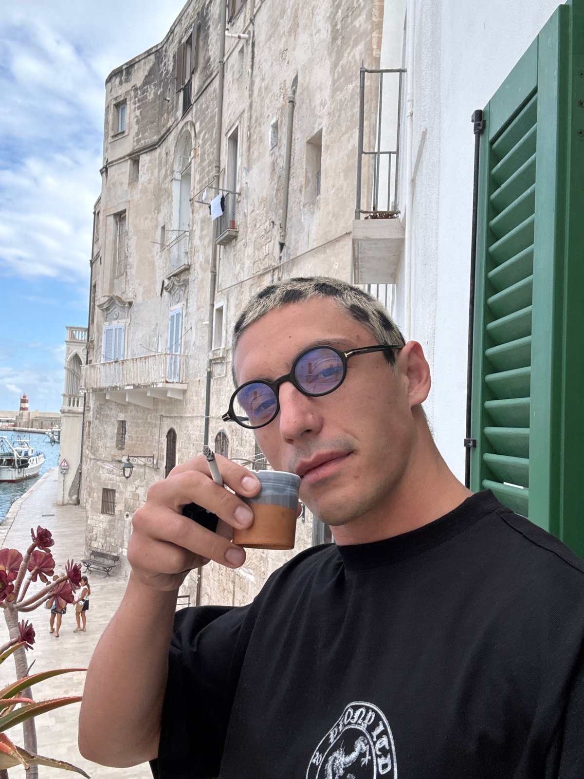 Person observed viewing Monopoli harbor from balcony overlook