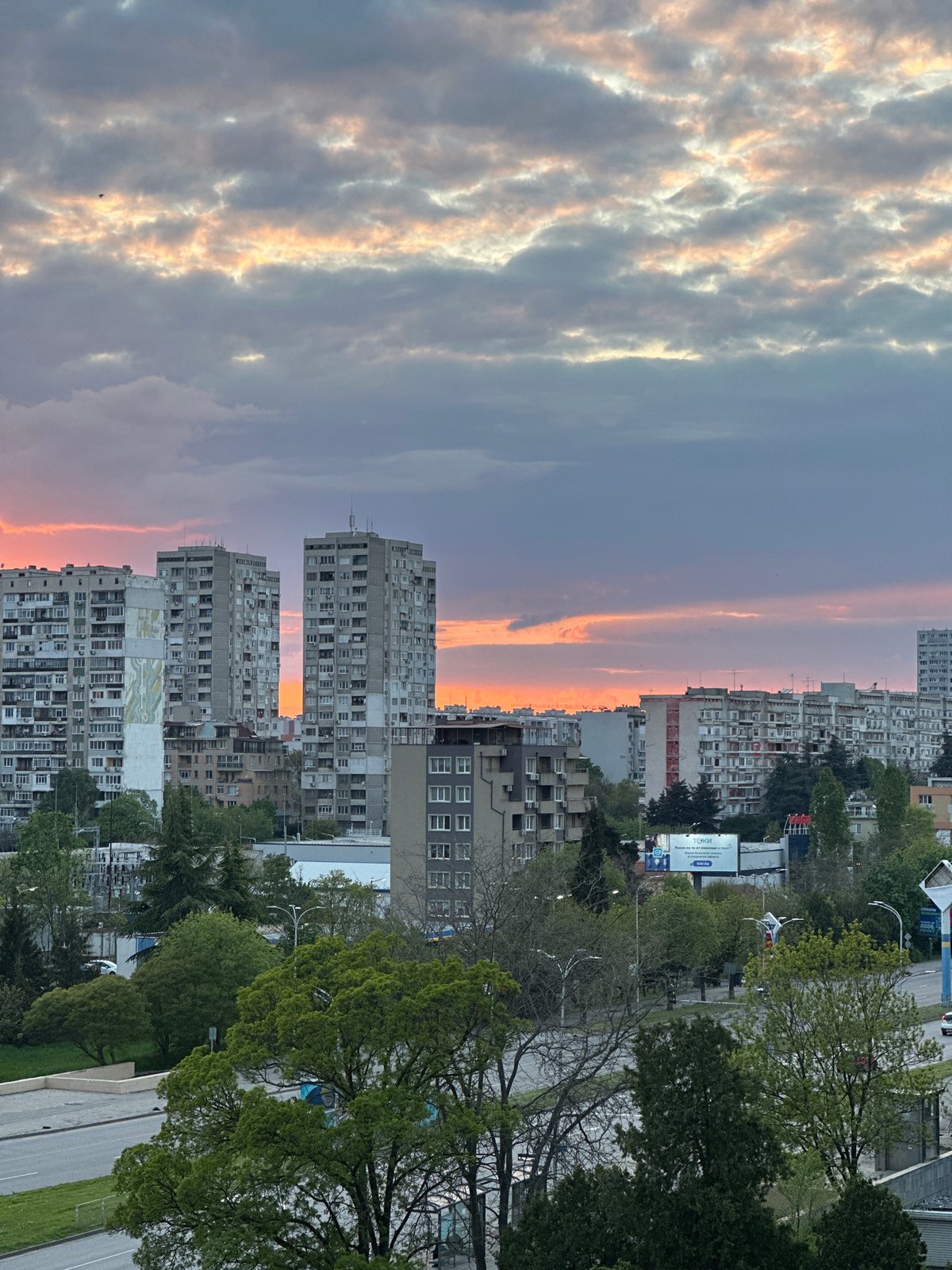 Urban sunset photography session captures dramatic sky, residential buildings