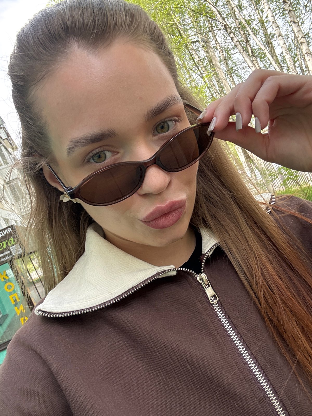 Woman documents spring flowers during morning walk in Chaikovsky