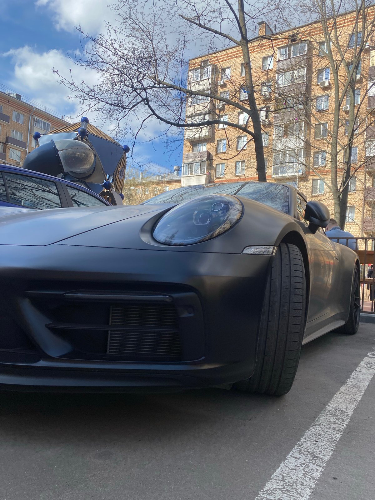Dark Porsche spotted parked in Moscow parking area