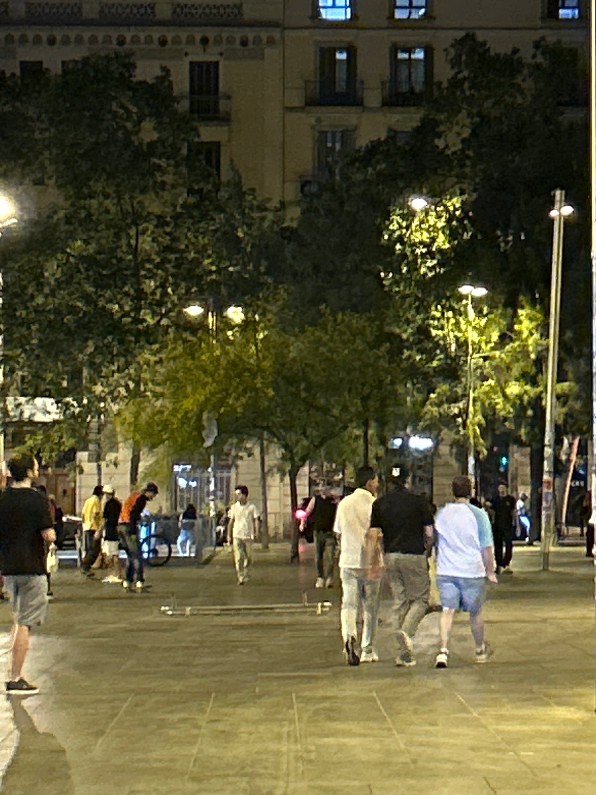 Friday night street hang near a Barcelona transit plaza