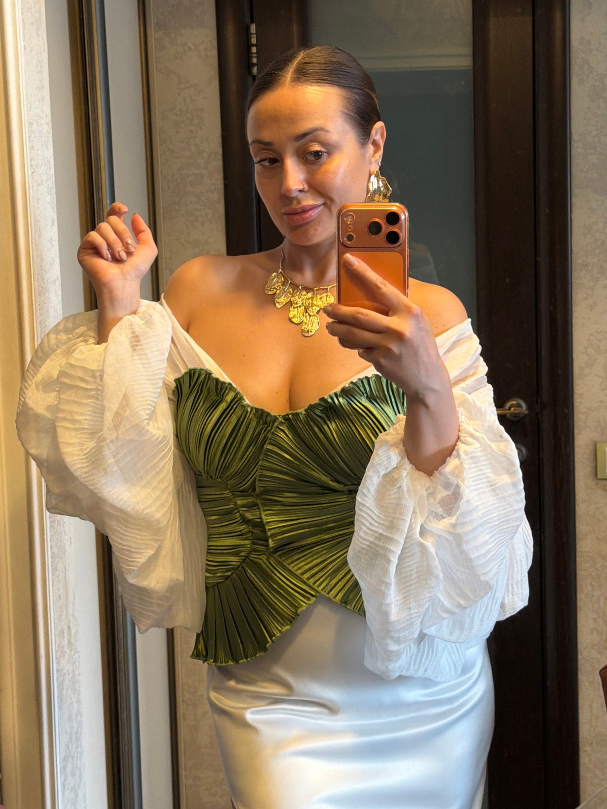 Woman takes mirror selfies in green outfit, Krasnoyarsk
