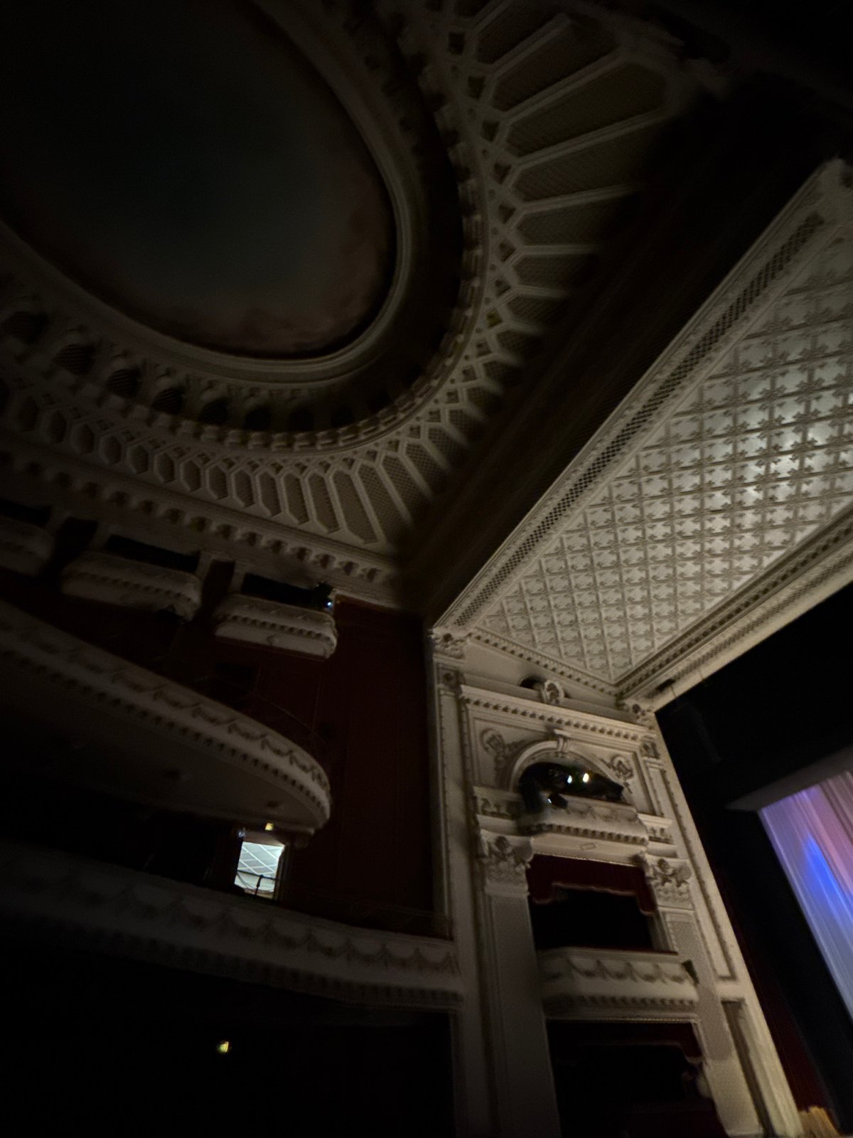Dance performance captured in ornate venue with geometric architecture