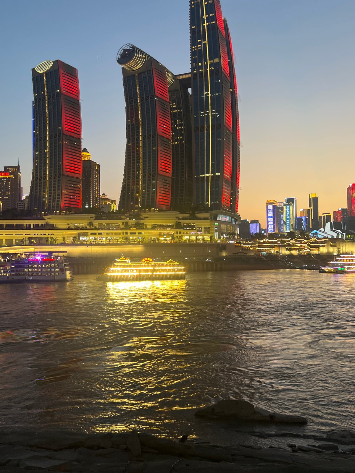 Chongqing riverfront skyline glowing at dusk