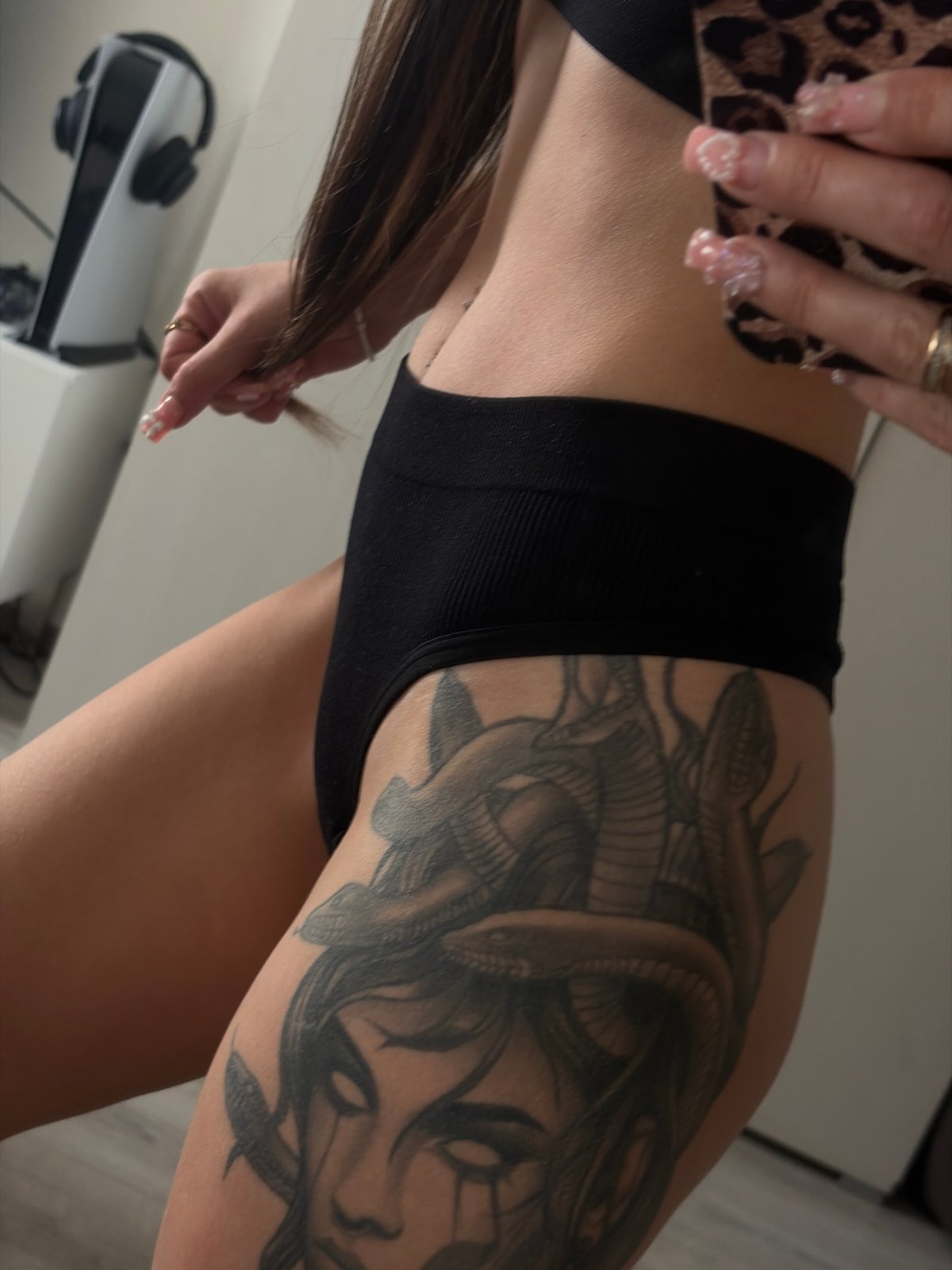 Person takes mirror selfies in athletic wear, Russia