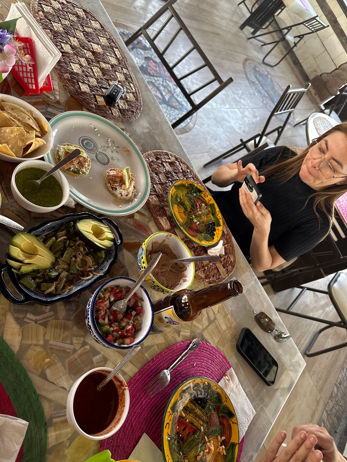 Woman dines while using phone in Mexican town