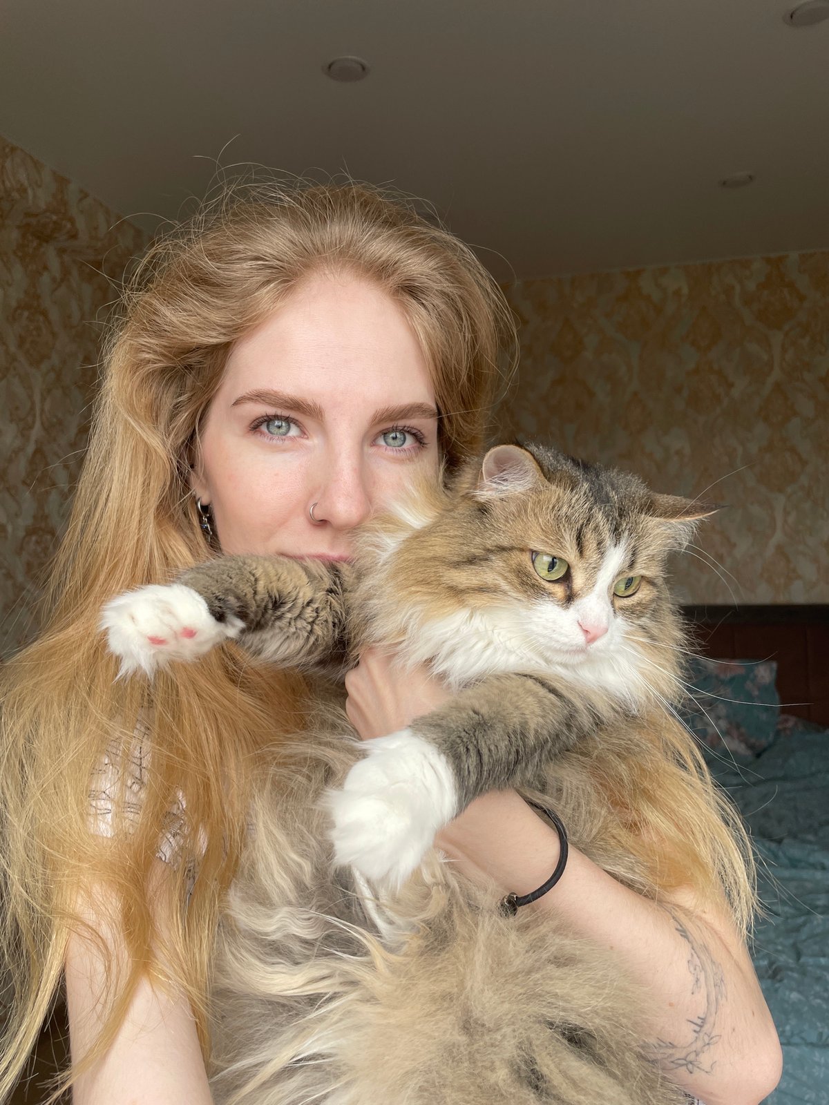 Woman holds fluffy cat in Izhevsk, Russia