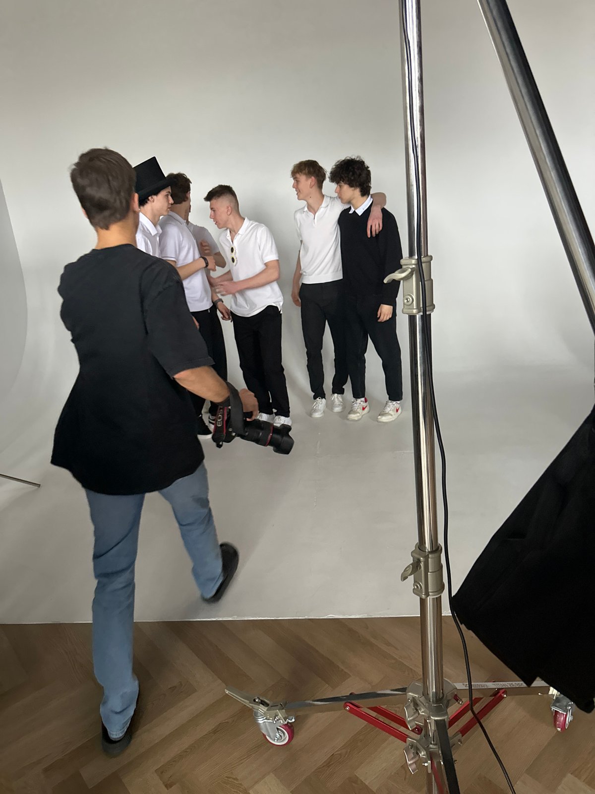 Studio photo shoot captures four men in coordinated outfits