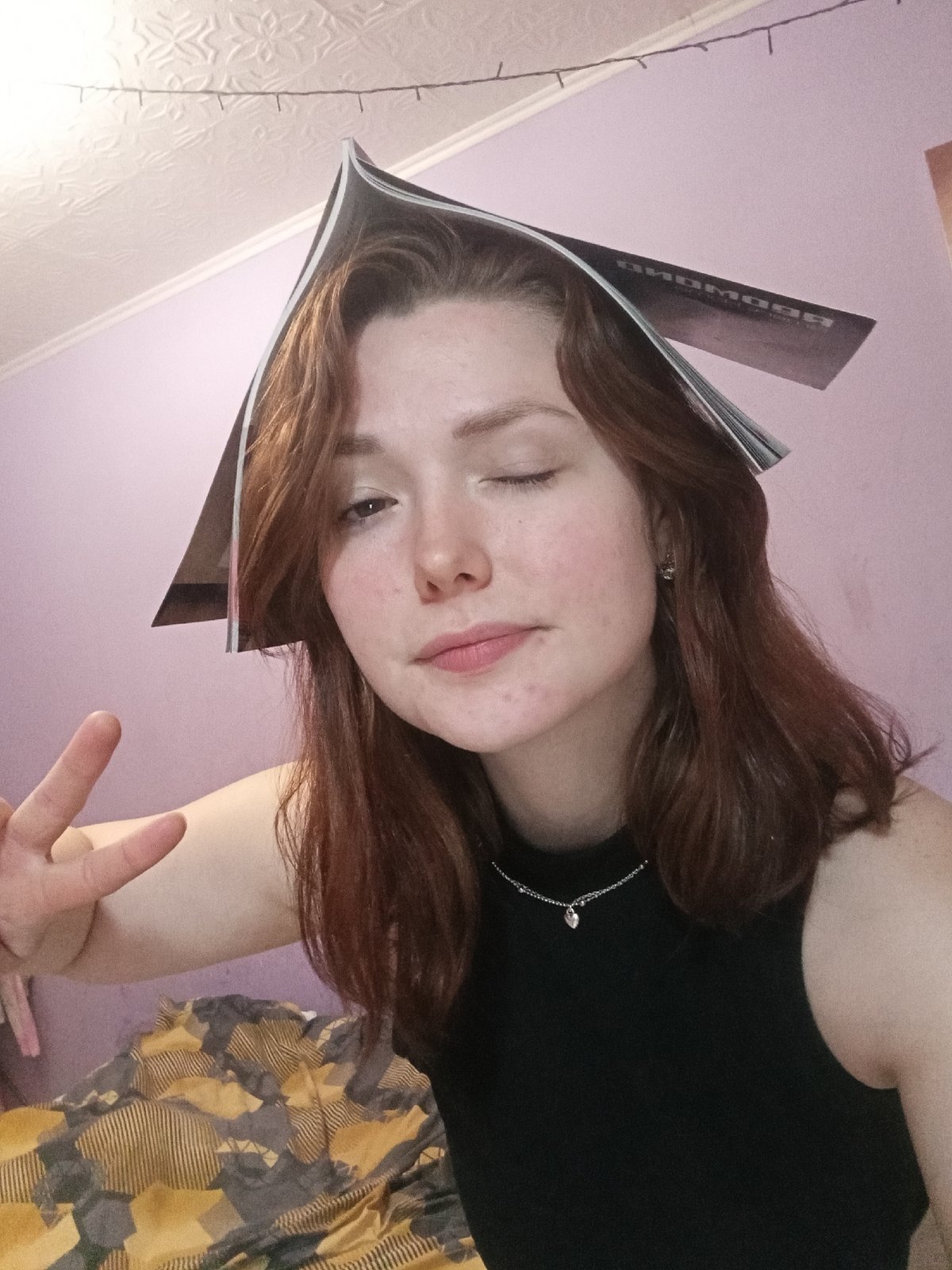 Woman drinks from bottle in room with colorful furniture