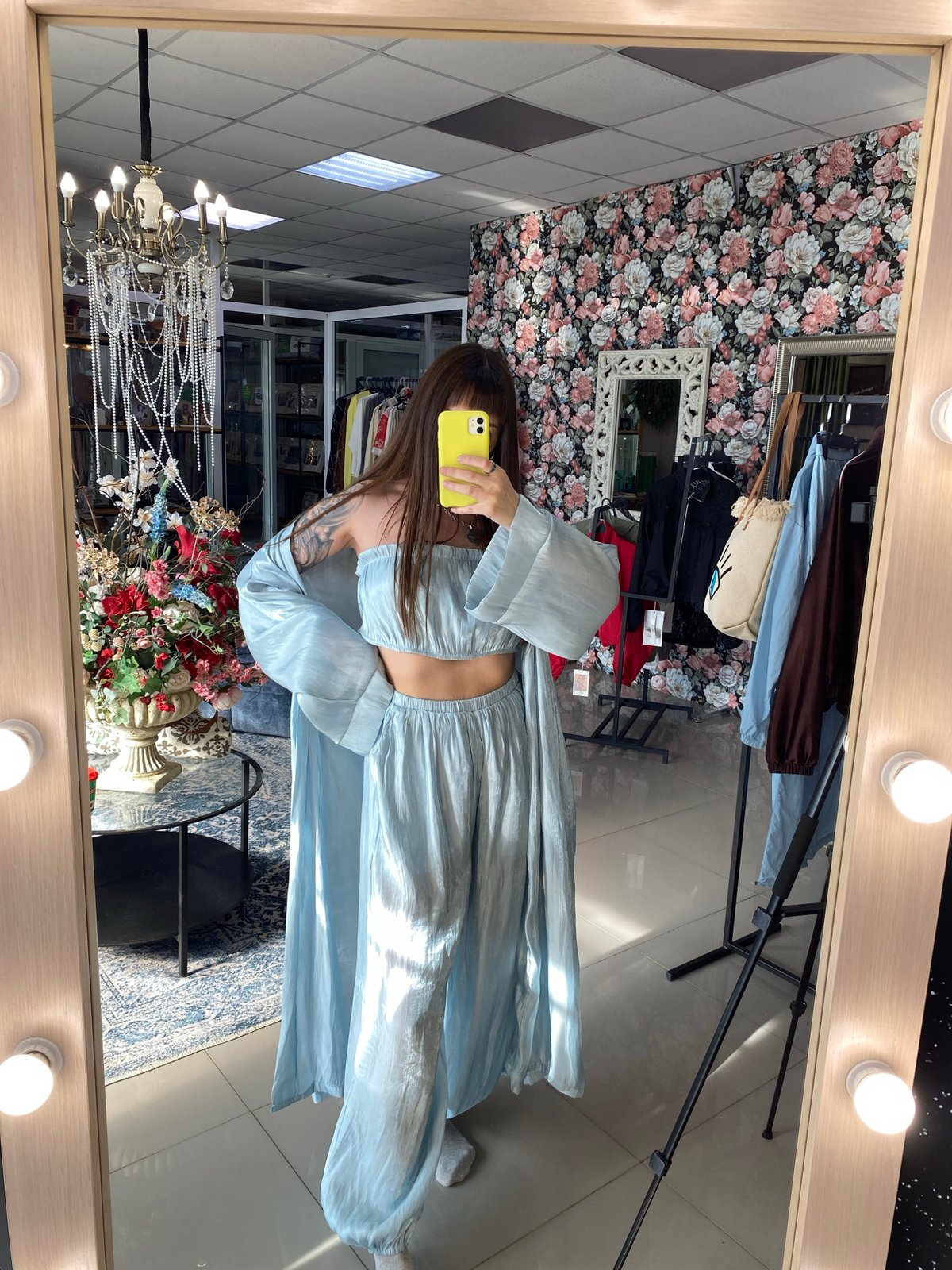 Customer tries on blue outfit at Votkinsk clothing store