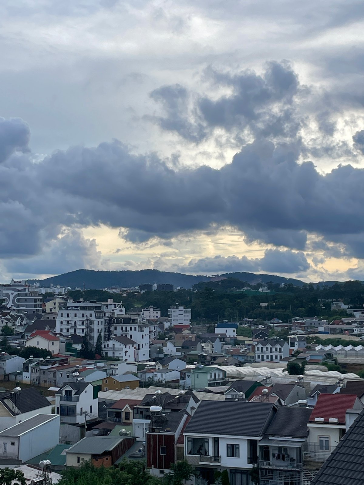 Đà Lạt rooftops under a stormy sky