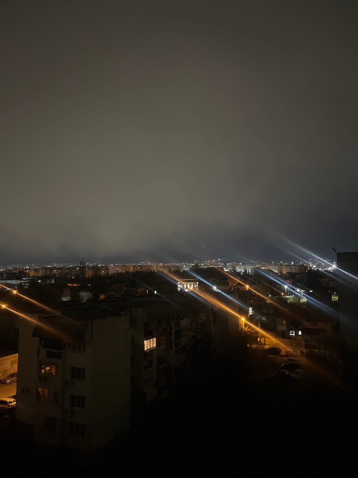 Foggy night blankets Sofia as spring blossoms glow under streetlights