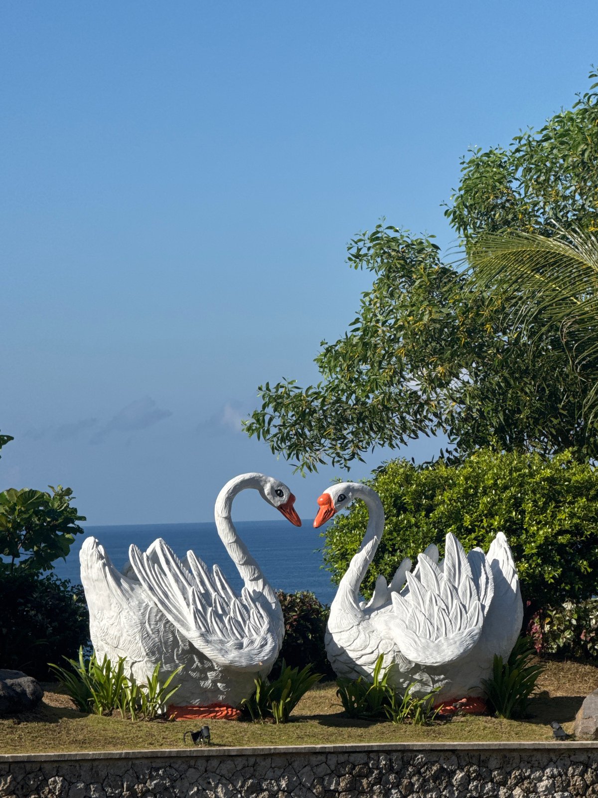 Six Balinese dancer statues observed overlooking ocean in Ungasan