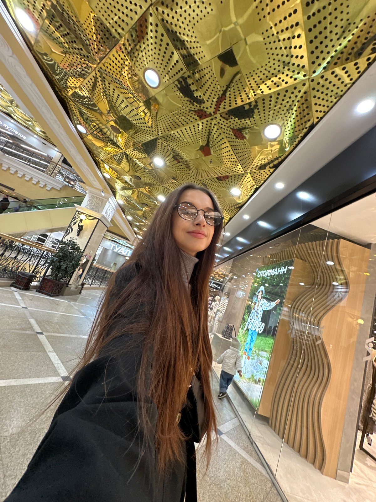 Mother and child explore Yekaterinburg shopping mall during morning visit