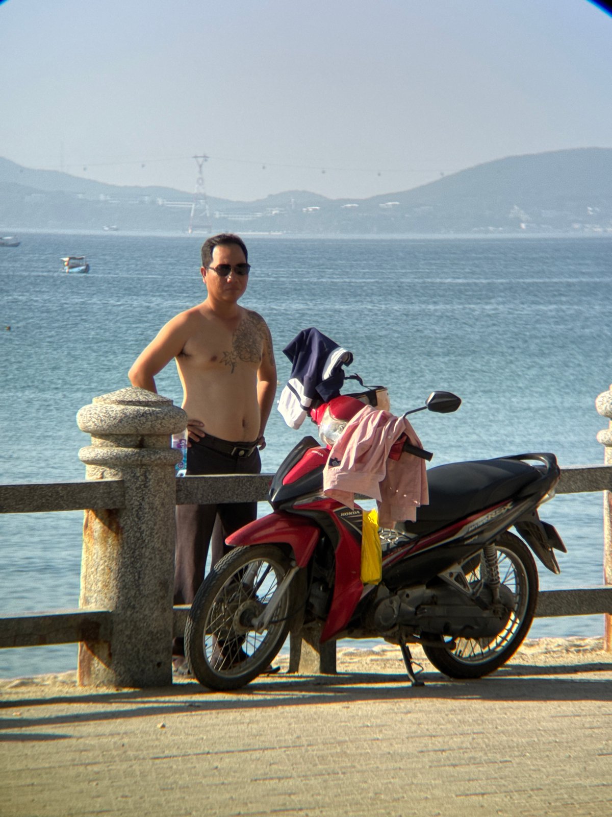 Hedge trimming and parked bikes along Nha Trang's seafront