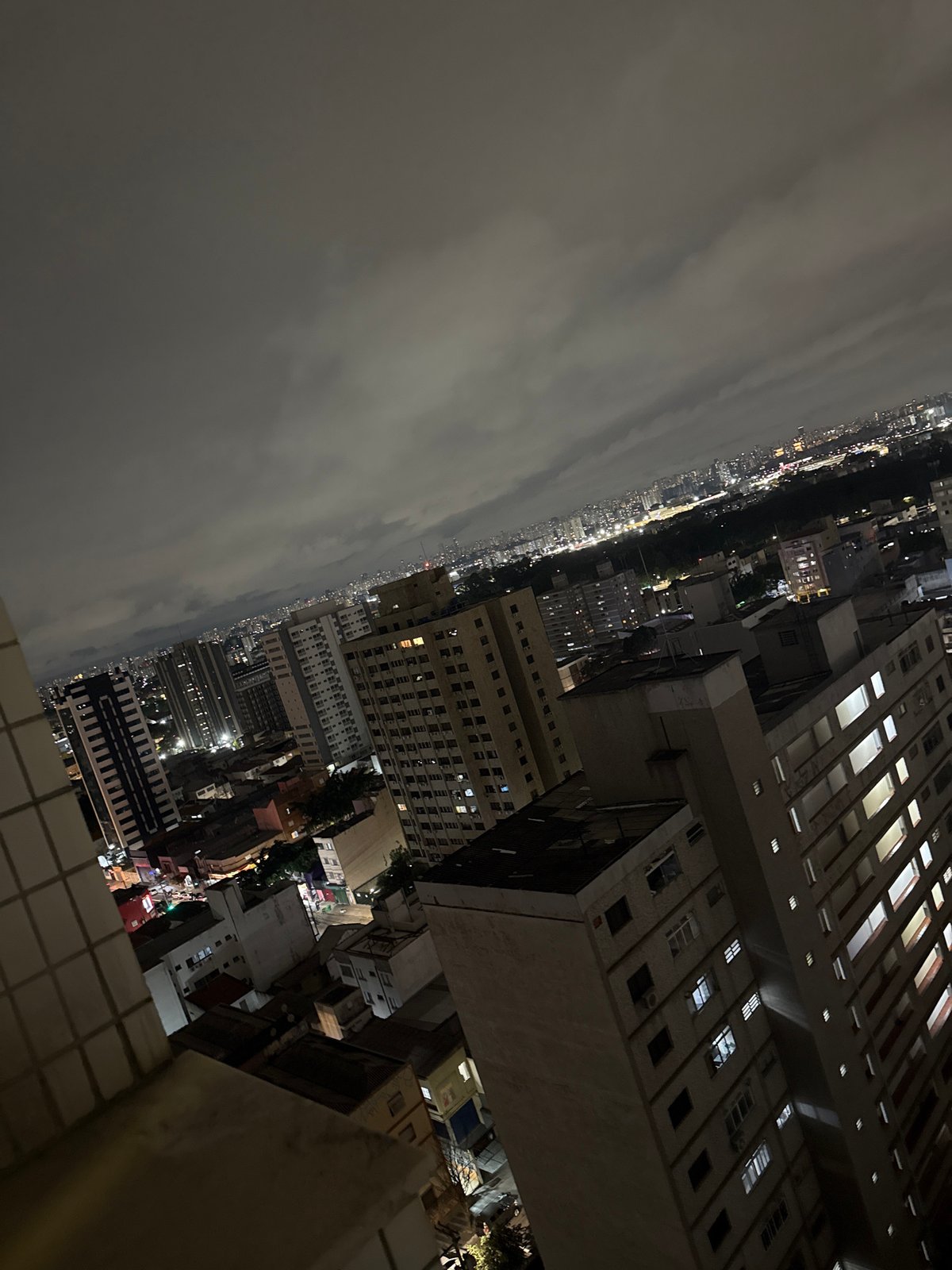 Nighttime aerial views document São Paulo cityscape under cloudy skies