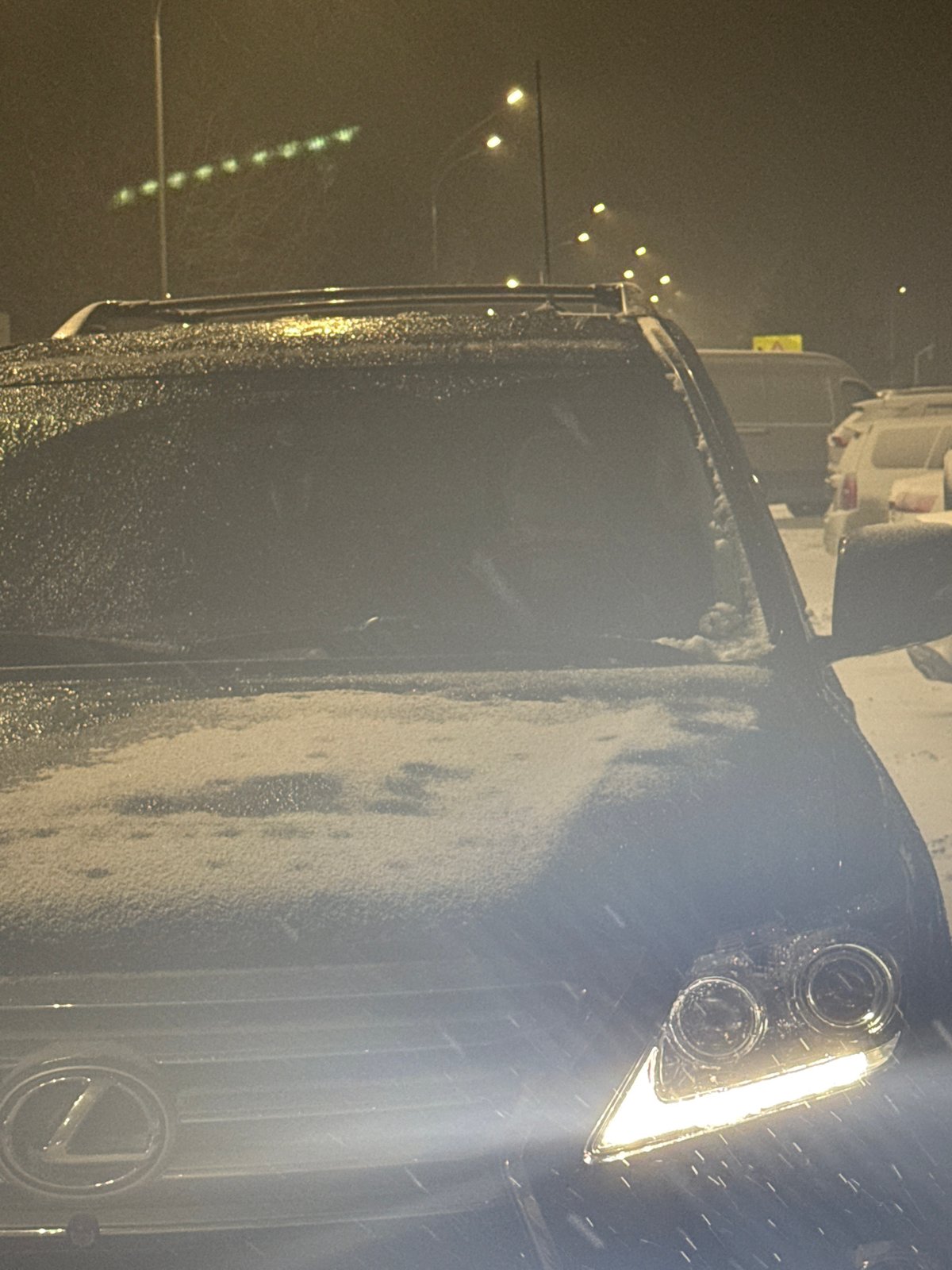 Evening car journey documented through snowy Nizhnevartovsk streets