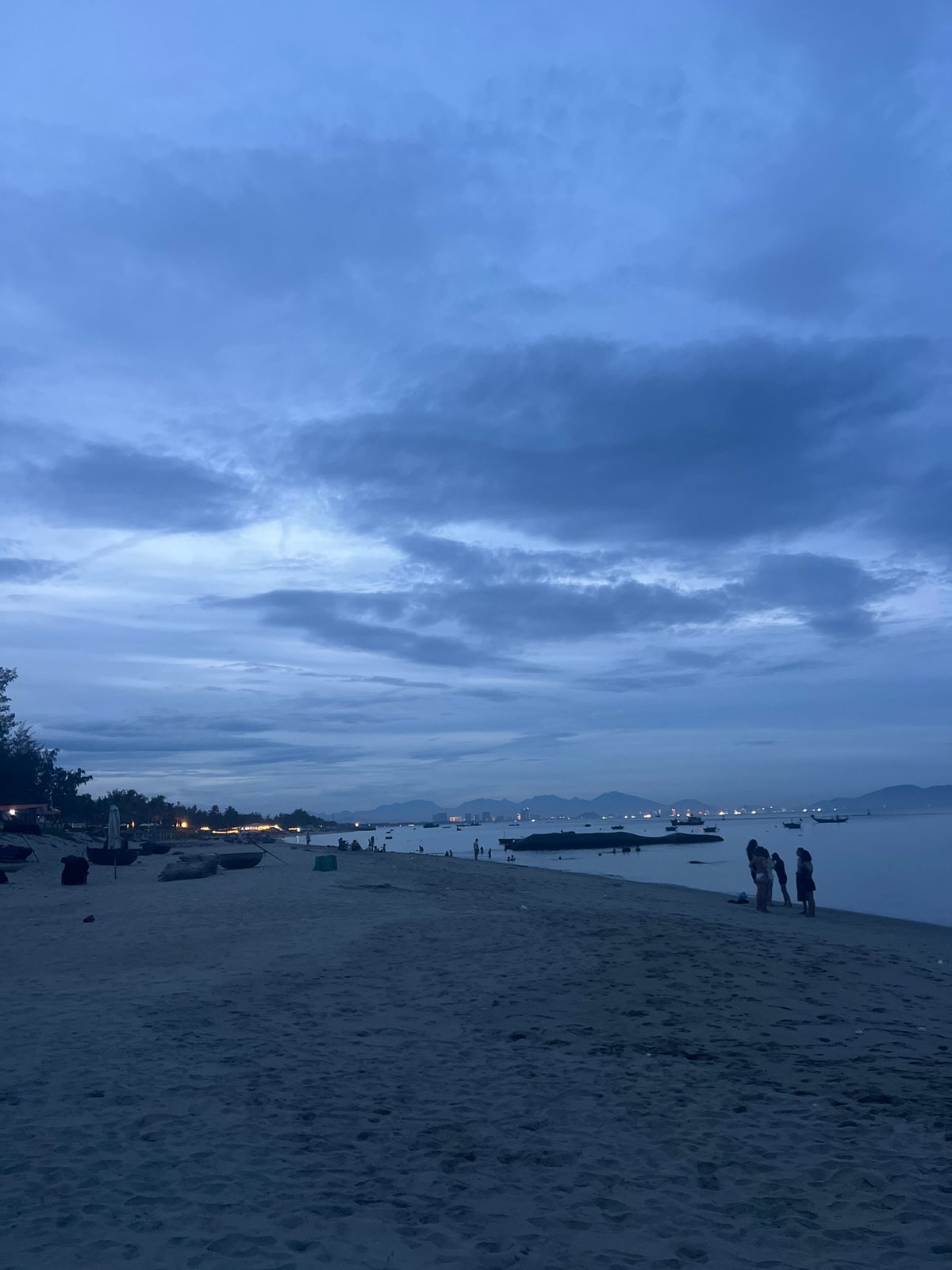 Hoi An beach at dusk: bonfires, empty sands, abandoned resort