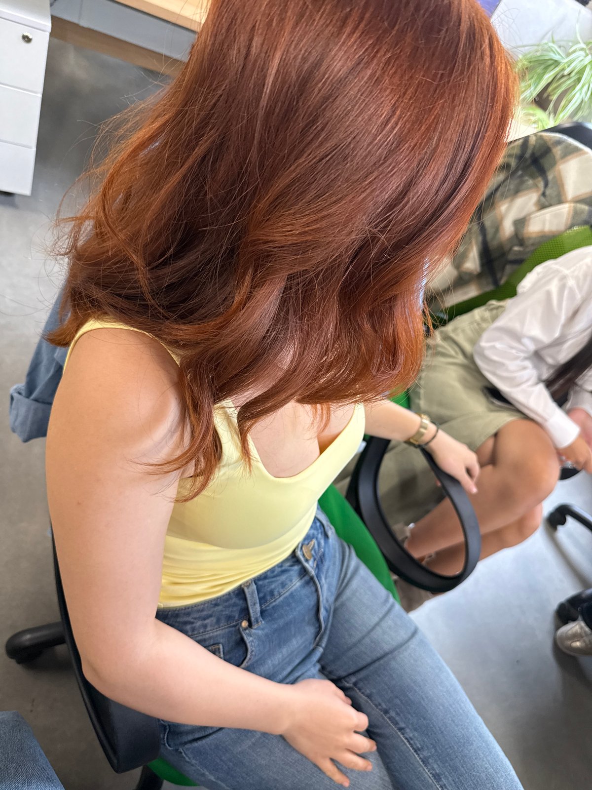Woman in yellow top photographed in office chair, Yerevan