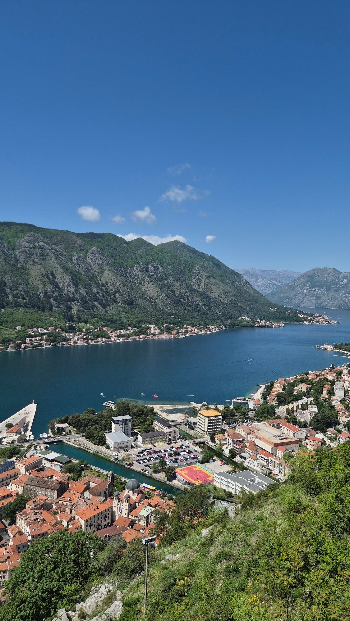 Tourists capture selfie overlooking scenic Bay of Kotor, Montenegro