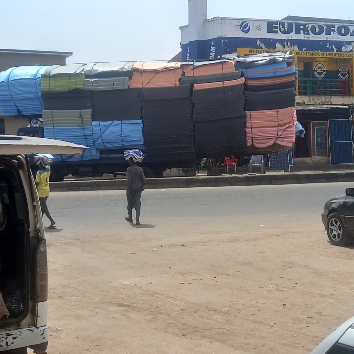 Everyday street life documented in Nigerian towns during midday