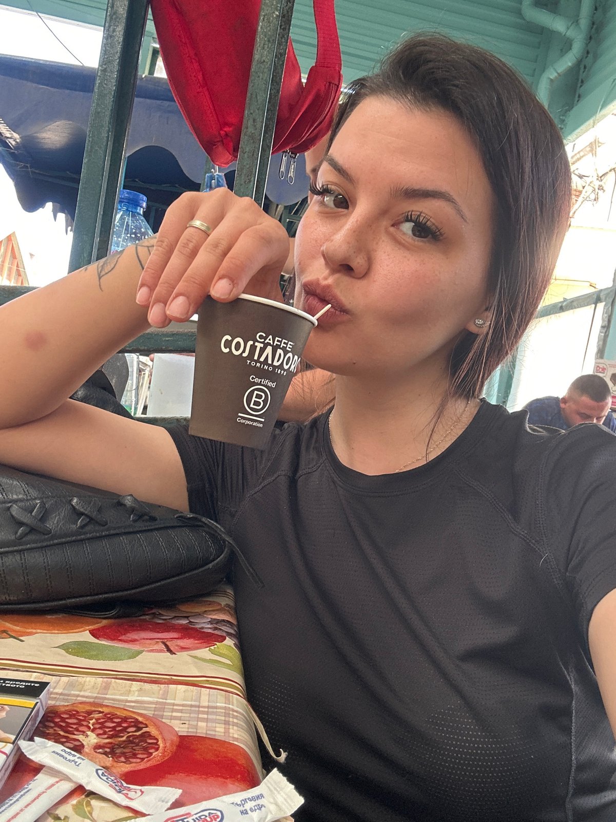 Coffee in hand at a Sliven outdoor market