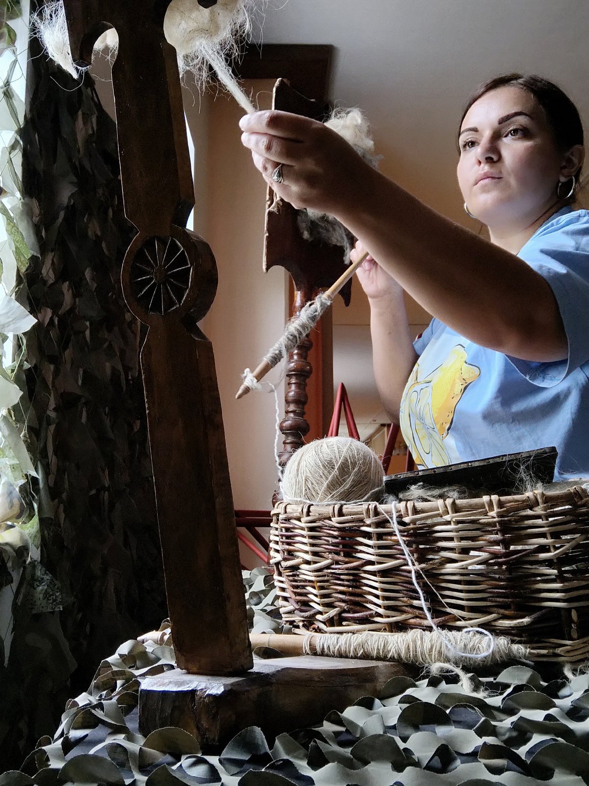 Woman practices traditional fiber spinning craft in Russian village