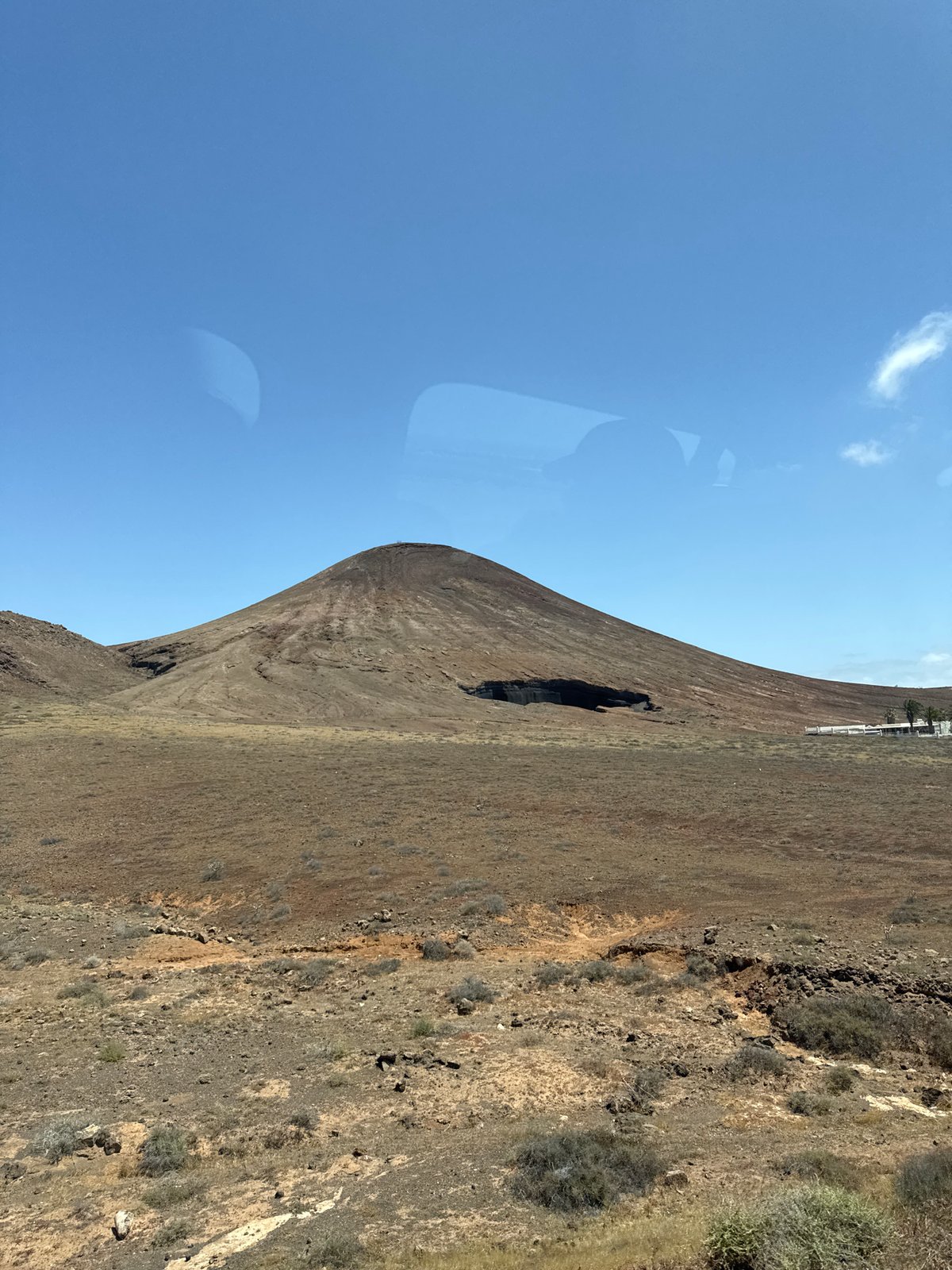 Volcanic cone with cave opening filmed in Arrecife