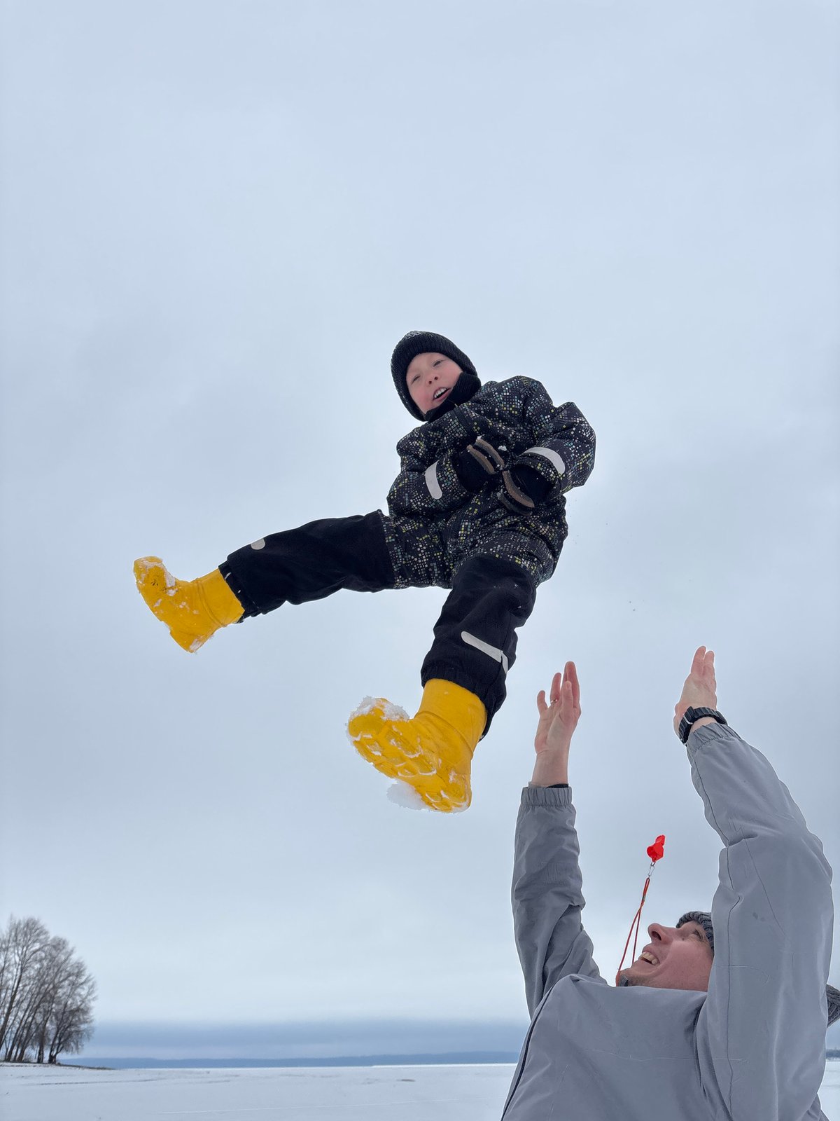 Child held upside down in snow in Chaikovsky, Russia