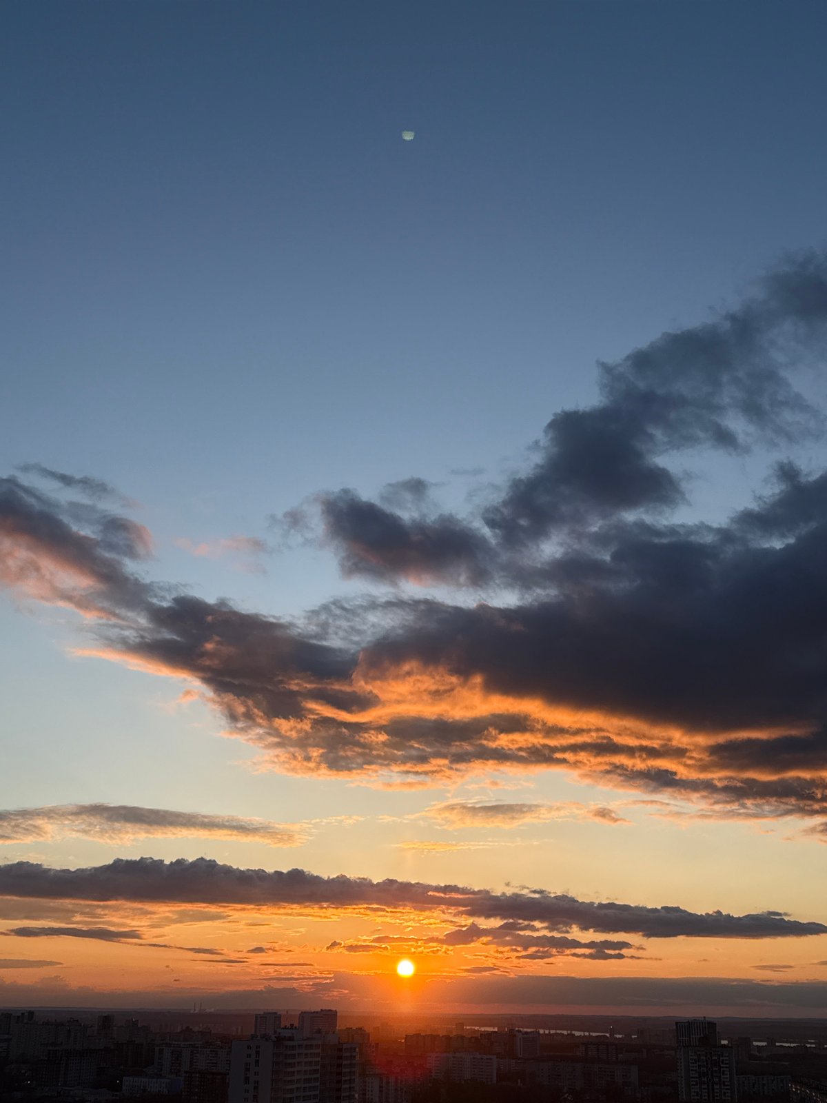 Dramatic sunset displays golden hues over Perm, Russia