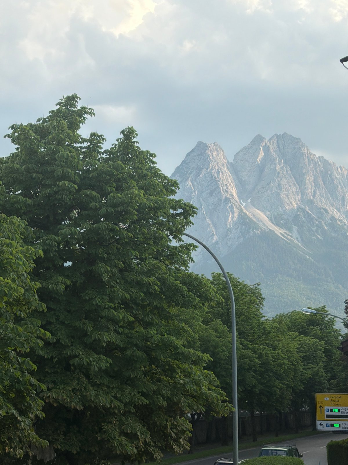 Rocky alpine peaks rise behind a European town's streets