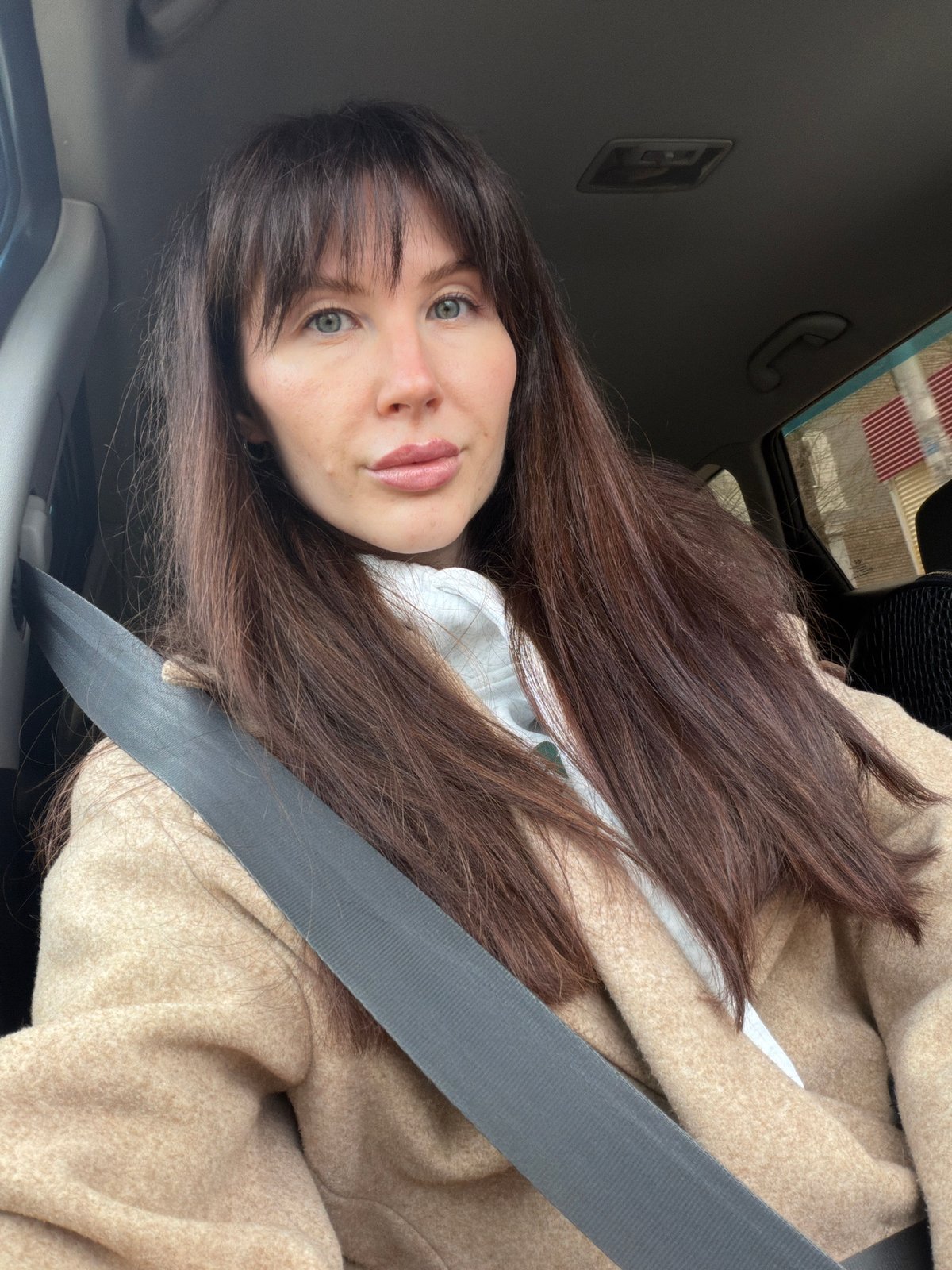 Woman in beige coat observed in car in Perm, Russia